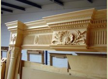 Detailed hand carving on an eight foot high mantelpiece waiting to be stained, polished and shipped to America